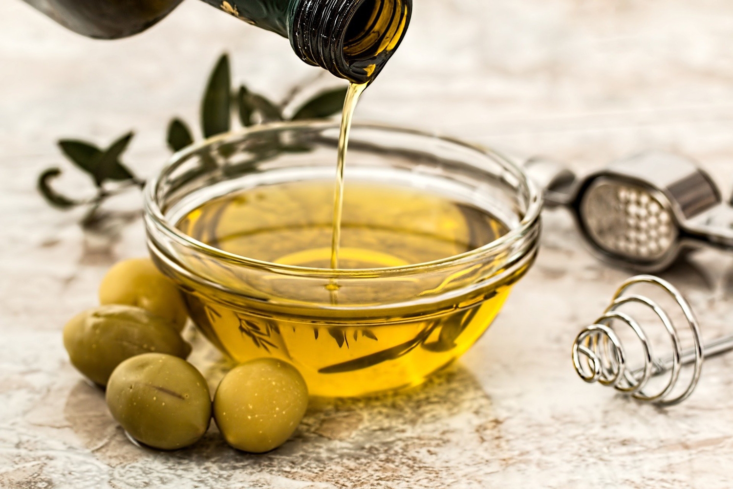 olive oil presented with olives and bottle